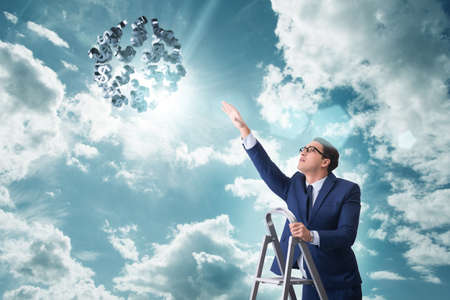 Businessman reaching out to dollarsの写真素材