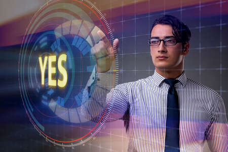 Businessman pressing virtual button YESの写真素材