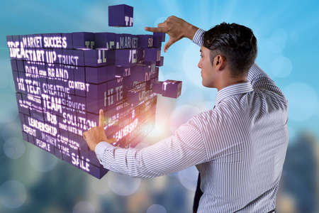 Businessman pressing virtual buttons in conceptの写真素材