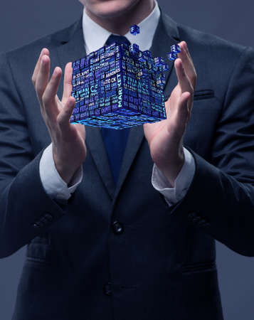 Businessman holding financial cube in business conceptの写真素材