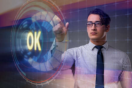 Businessman pressing virtual button OKの写真素材
