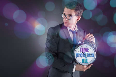 Young businessman time importance conceptの写真素材