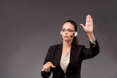 Young woman businesswoman pressing virtual buttonsの写真素材