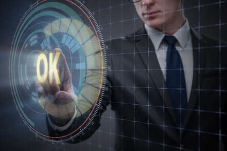 Businessman pressing virtual button OKの写真素材