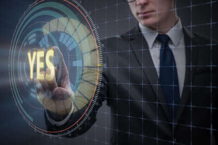 Businessman pressing virtual button YESの写真素材
