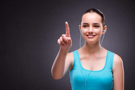 Woman in sports concept pressing buttonsの写真素材