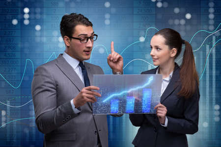 Business people discussing stock chart trends