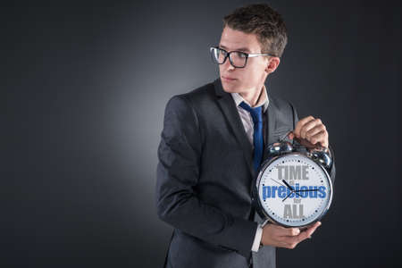 Young businessman time importance conceptの写真素材