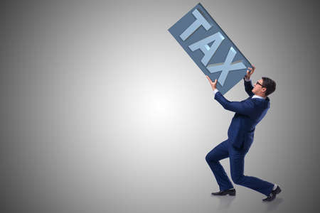 Businessman struggling with high taxesの写真素材