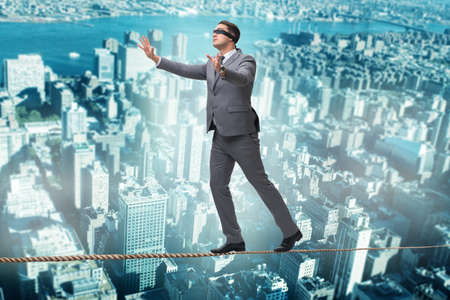 Man walking in tight rope blindfoldの写真素材