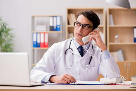 Doctor consulting patient over the phoneの写真素材