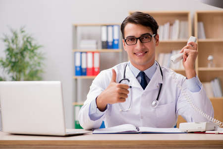 Doctor consulting patient over the phoneの写真素材