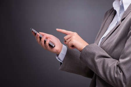 Businesswoman using mobile phone in business concept