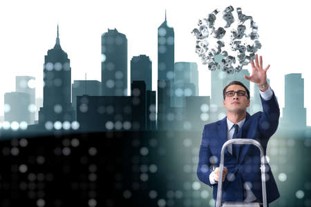 Businessman reaching out to dollarsの写真素材