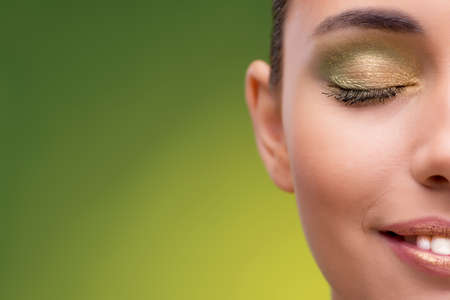 Beautiful woman on green backgroundの写真素材