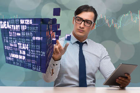 Businessman with tablet computer pressing buttonsの写真素材