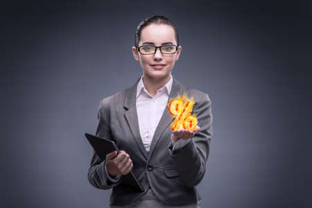 Businesswoman with percent sign in high interest conceptの写真素材