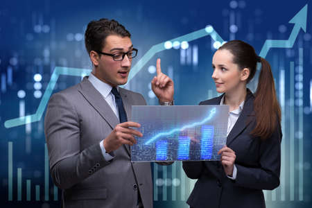 Business people discussing stock chart trends
