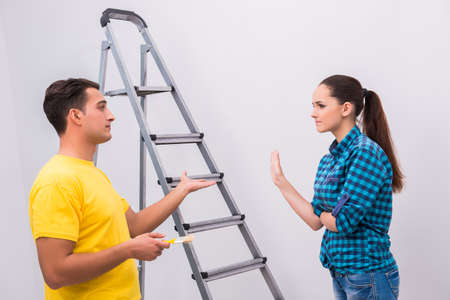 Young couple painting wall at homeの写真素材