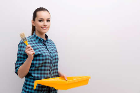 Woman painting house in DIY conceptの写真素材