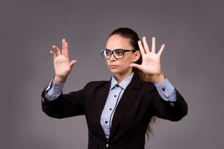 Young woman businesswoman pressing virtual buttonsの写真素材