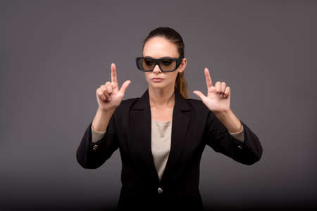 Young woman businesswoman pressing virtual buttonsの写真素材