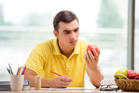 Young artist drawing apple on paperの写真素材
