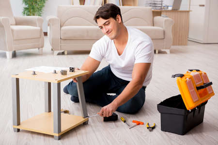 Man assembling shelf at homeの写真素材