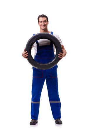Handsome tyre repairman isolated on whiteの写真素材