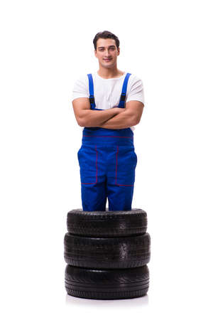 Handsome tyre repairman isolated on whiteの写真素材