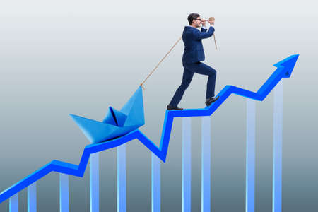 Businessman pulling boat over line chart