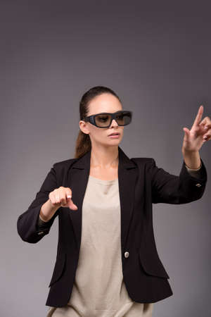 Young woman businesswoman pressing virtual buttons