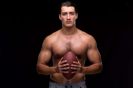 Ripped muscular man with american footballの写真素材