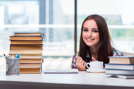 Young woman student with many booksの写真素材