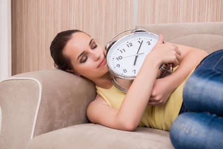 Young woman asleep on the sofa