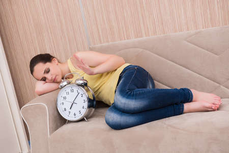 Young woman asleep on the sofaの写真素材