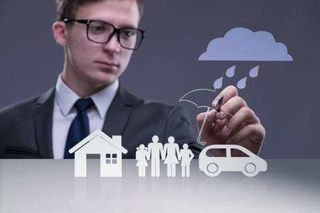 Young businessman in insurance conceptの写真素材