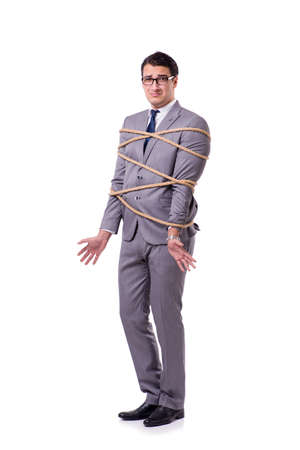 Businessman tied up with rope isolated on whiteの写真素材