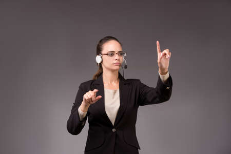 Young woman businesswoman pressing virtual buttonsの写真素材