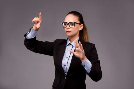 Young woman businesswoman pressing virtual buttonsの写真素材