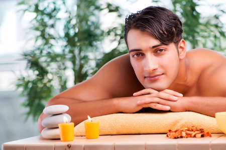 Young handsome man during spa procedureの写真素材
