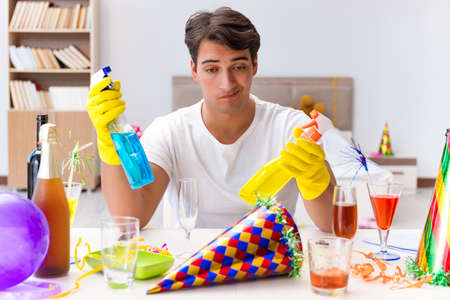Man cleaning the house after christmas party