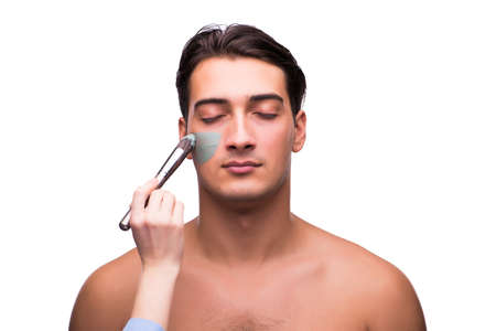 Man with face mask being applied on whiteの写真素材