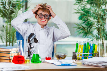 Young crazy chemist working in the labの写真素材