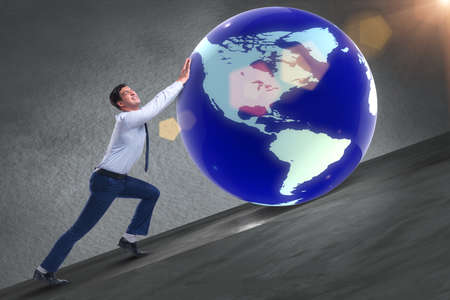 Businessman pushing earth in business conceptの写真素材