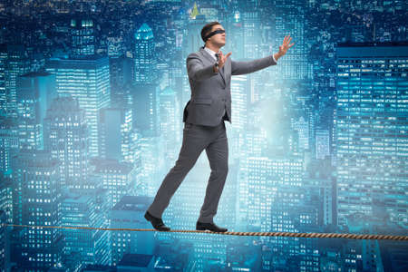 Man walking in tight rope blindfoldの写真素材