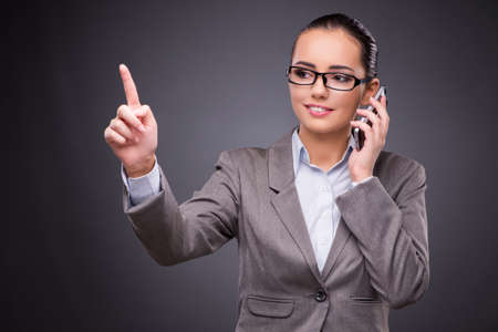Businesswoman using mobile phone in business conceptの写真素材