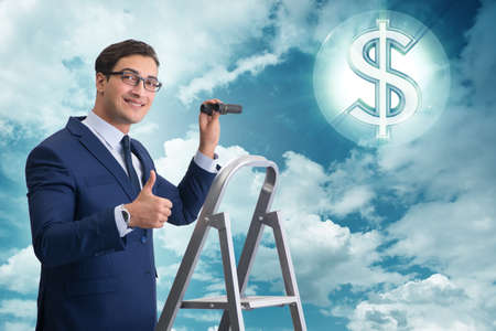 Businessman looking for dollars with binocularsの写真素材