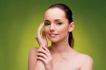 Beautiful woman on green backgroundの写真素材