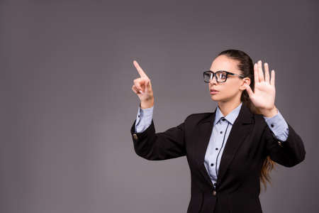 Young woman businesswoman pressing virtual buttonsの写真素材